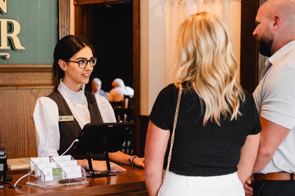 Concierge welcoming guests to restaurant