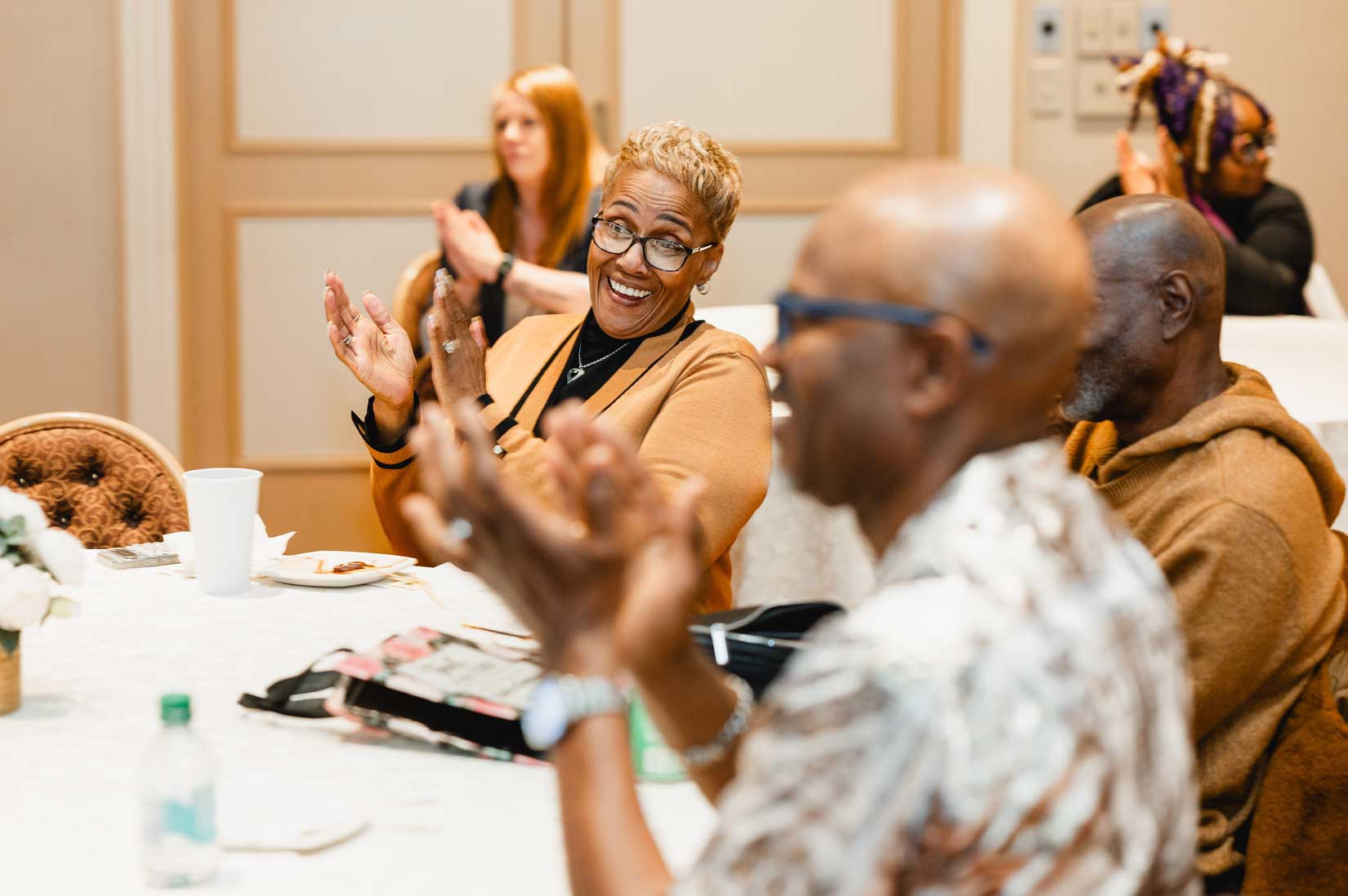 people smiling and applauding